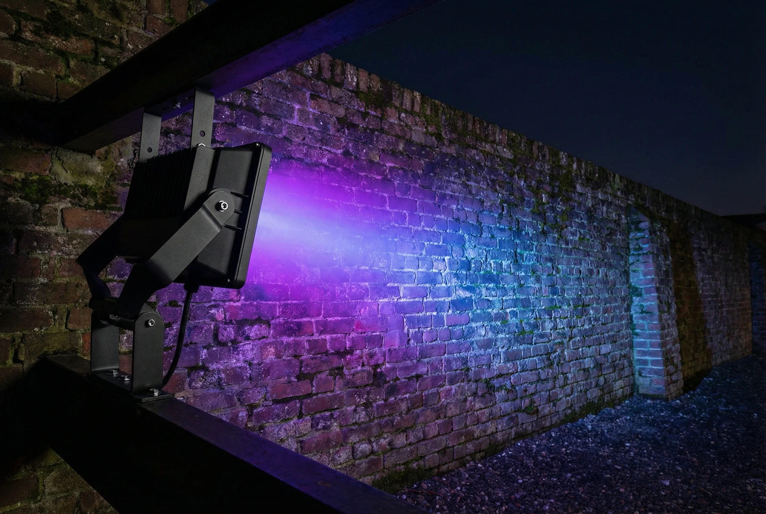 BRmesh LED flood light illuminating outdoor brick wall with RGB color wash